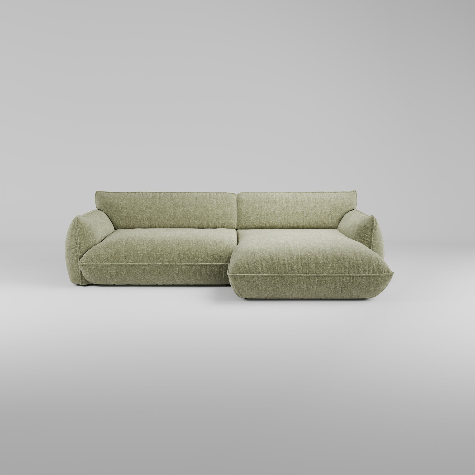 Morandi XL Ecksofa (Rechts) in hellem Grün mit skulpturalem Design vor weißem Hintergrund.
